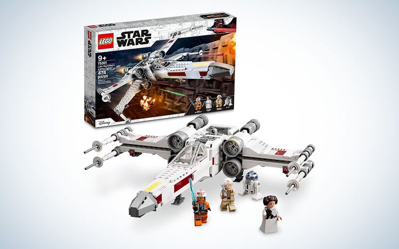 A Star Wars X-Wing Fighter plane with Princess Leia, Obi-Wan Kenobi, Luke Skywalker, and R2D2 figurines.