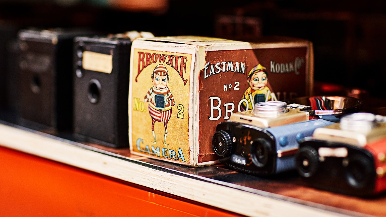 a shelf containing the Brownie vintage camera in its box