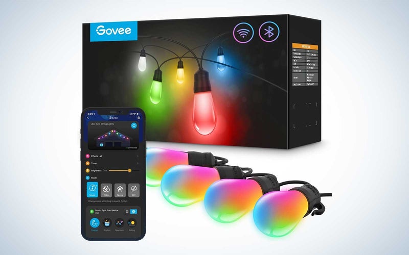 Govee smart lights lit up with colors next to the app and the packaging on a plain background