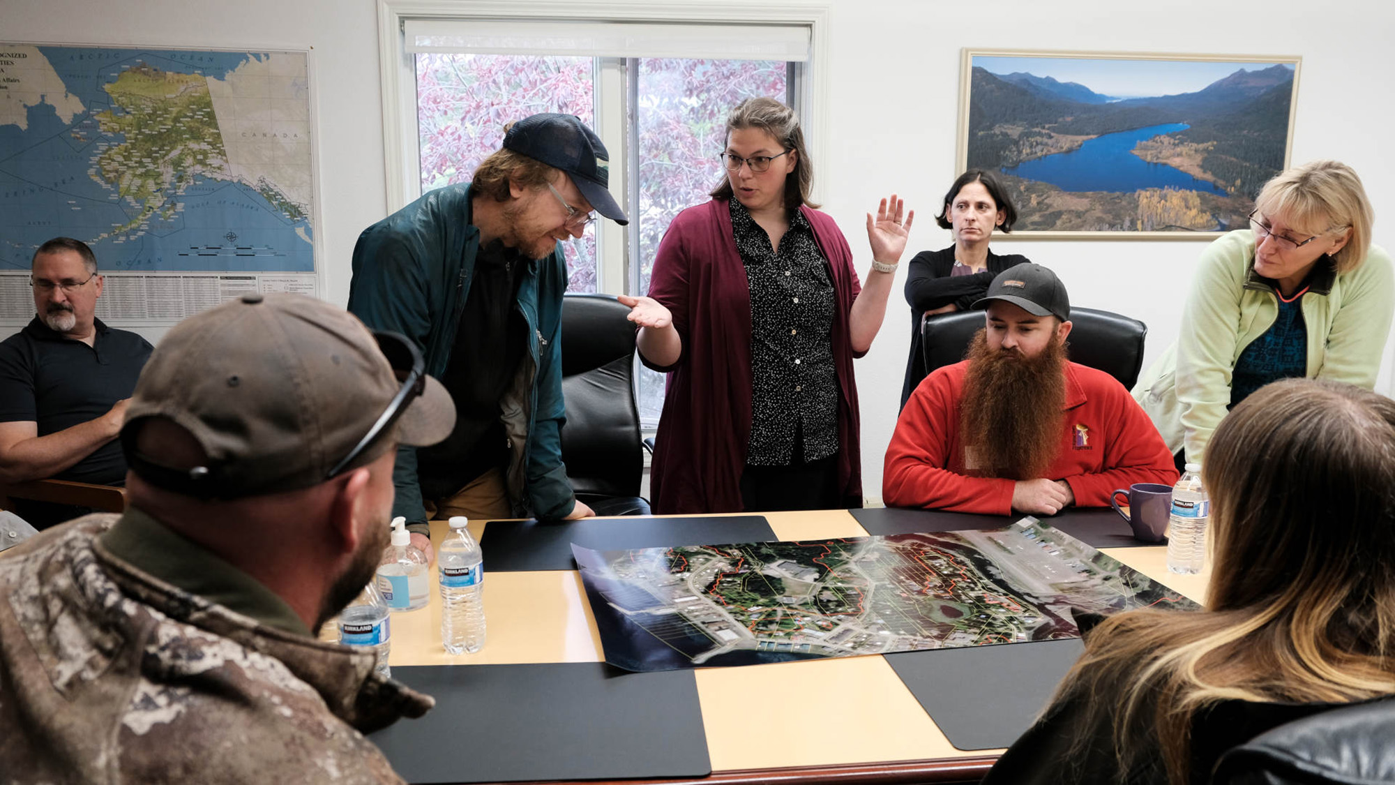 Top: In Seldovia, Alaska, city manager Heidi Geagel (center) discusses the town’s tsunami evacuation zone with local geologist Bretwood Higman (left), tsunami scientists Barrett Salisbury (right) and Elena Suleimani (far right), and community members. 
