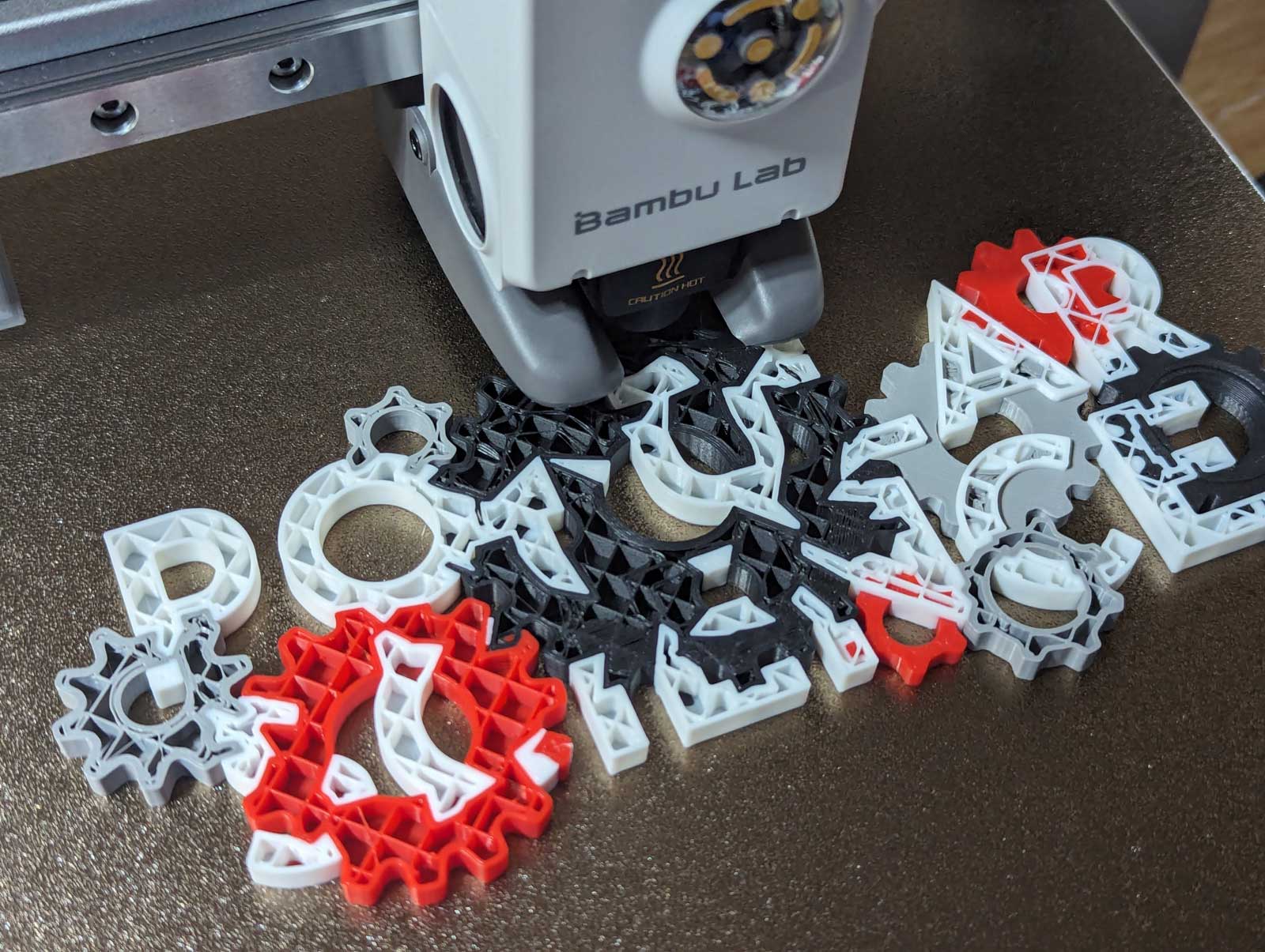 A close-up of the Bambu Labs A1 3D printer's print head as it prints