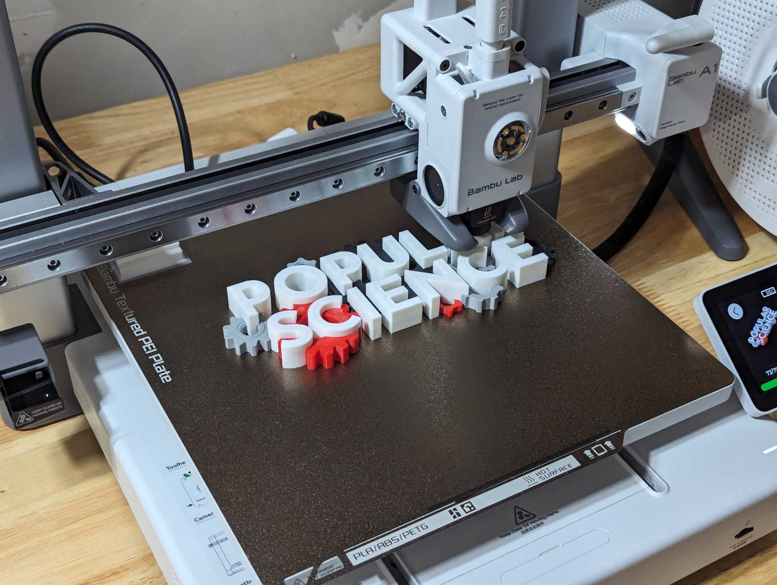 Bambu Labs A1 3D Printer with a print in-progress on its bed