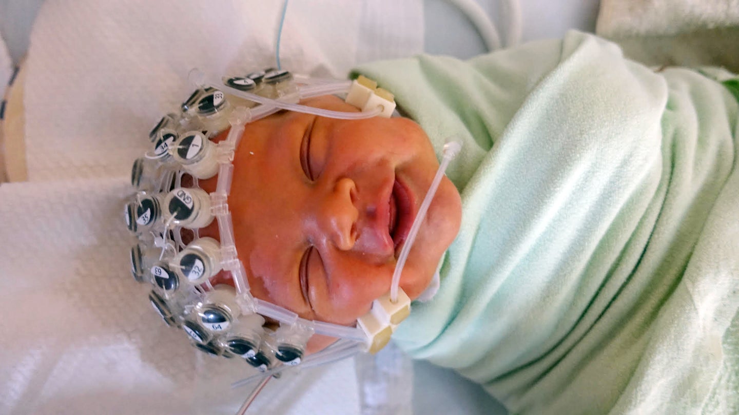 Newborn baby participating in listening experiment