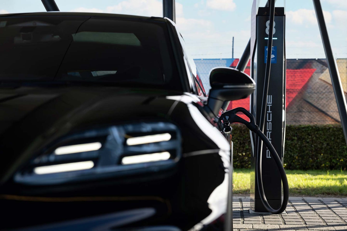 A Porsche SUV parked at an electric charging station