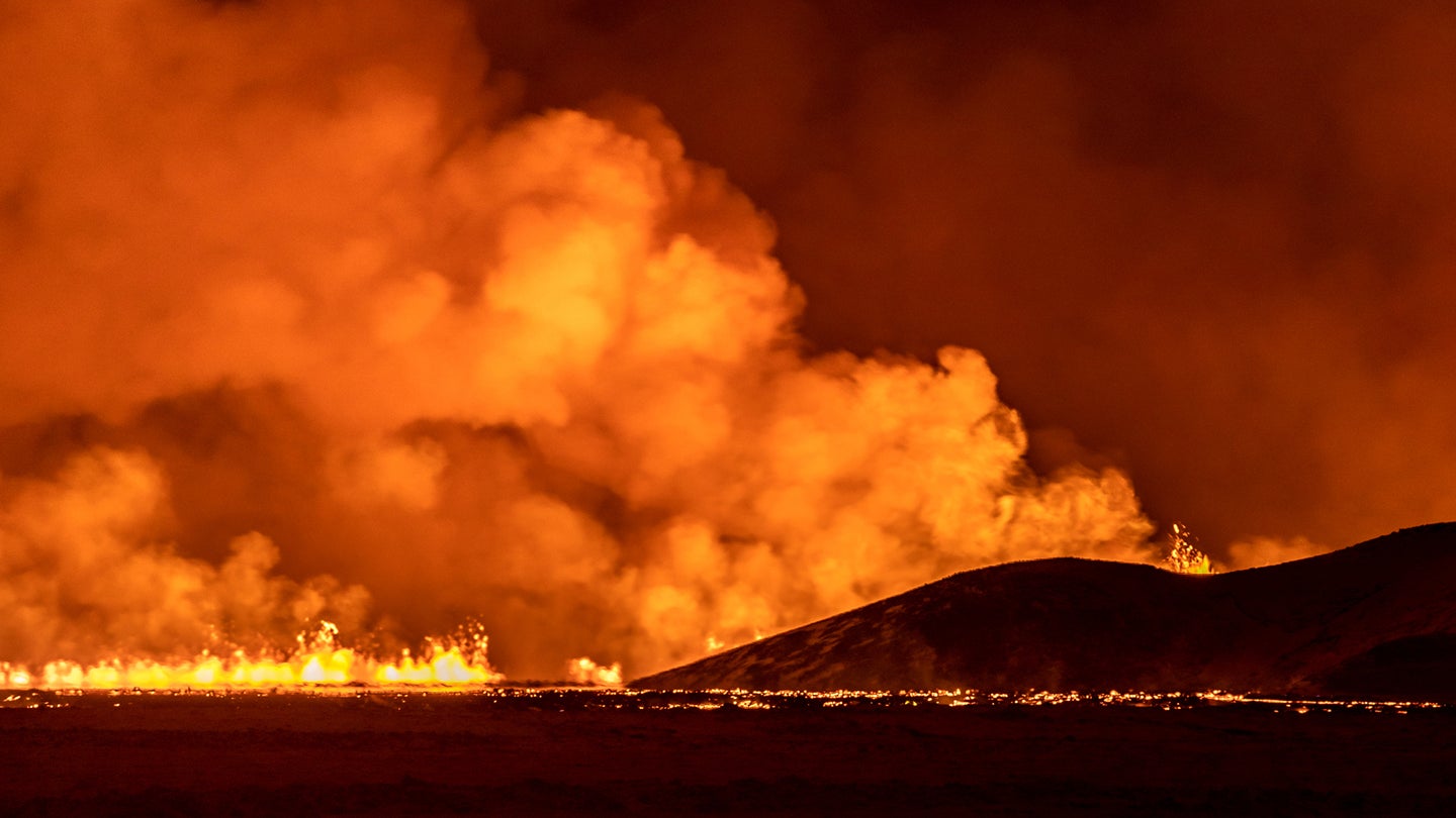 A volcano spews lava and smoke as it erupts near the town of Grindavik, Iceland.