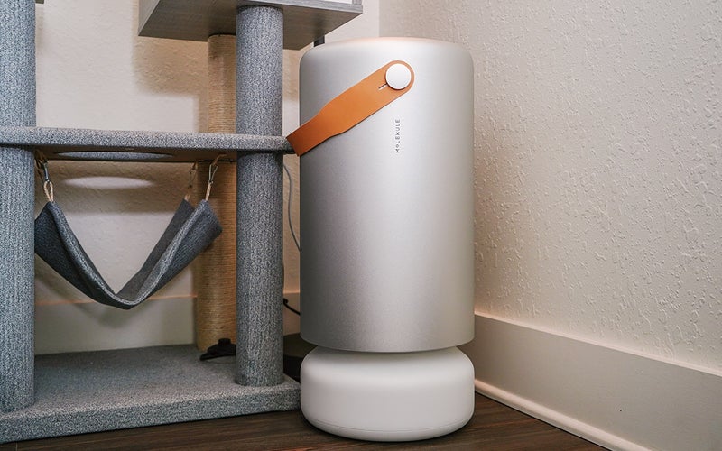 Molekule air pro air purifier for pets next to a cat tower
