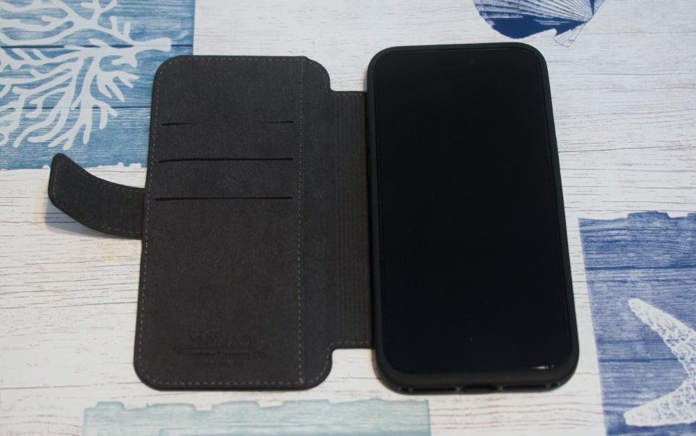 A black Nomad Modern Leather Folio case on a table