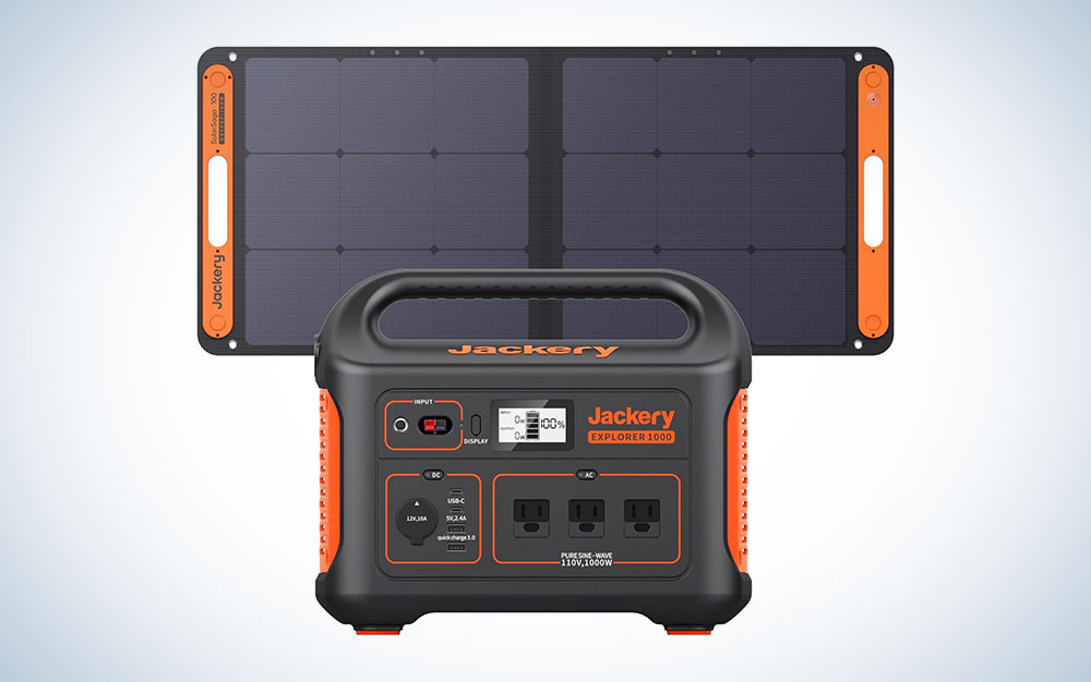 A Jackery 1000 solar generator and 100W solar panel on a plain background