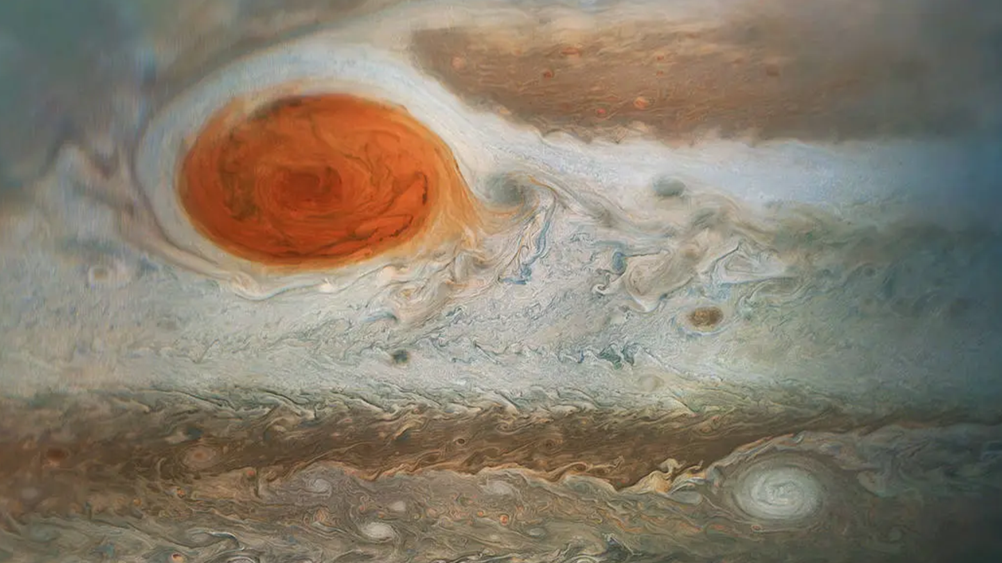 Jupiter’s iconic Great Red Spot and the surrounding turbulent zones, shown in shades of white and brown.