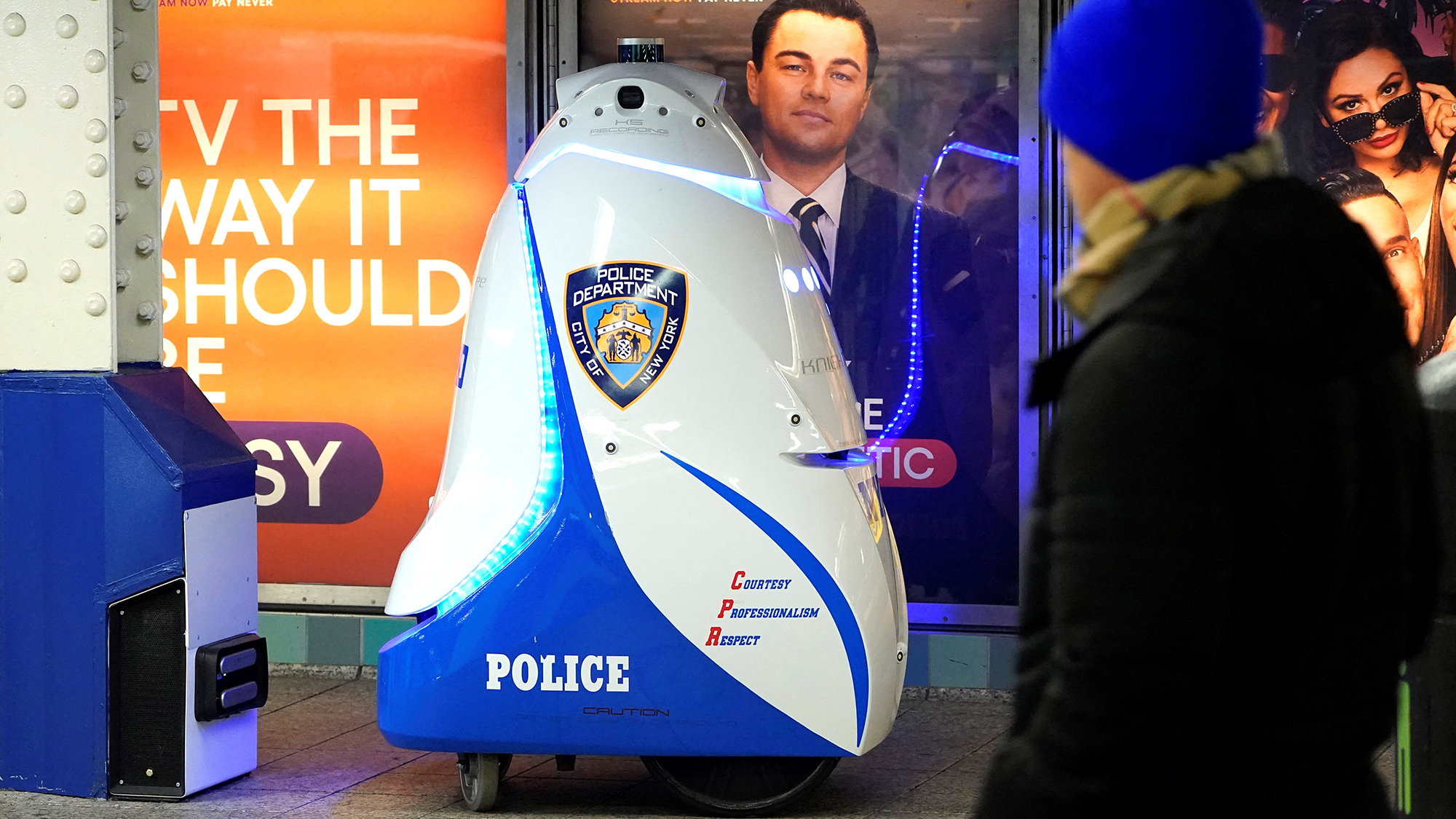 People walk past the K5 robot used by the New York City Police Department (NYPD) in the Times Square subway station in New York on November 28. 2023.