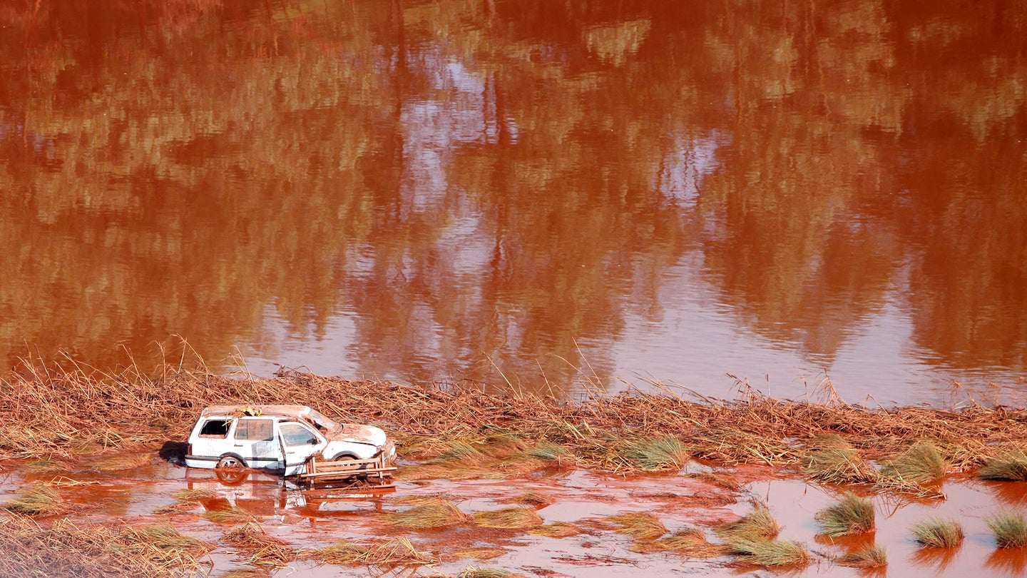 Abandoned car in aluminum red mud spill