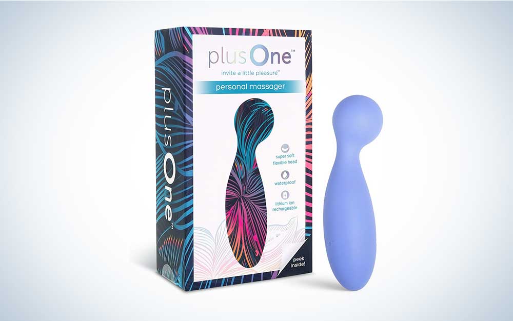 A periwinkle plusOne personal massager on a plain gray blackground