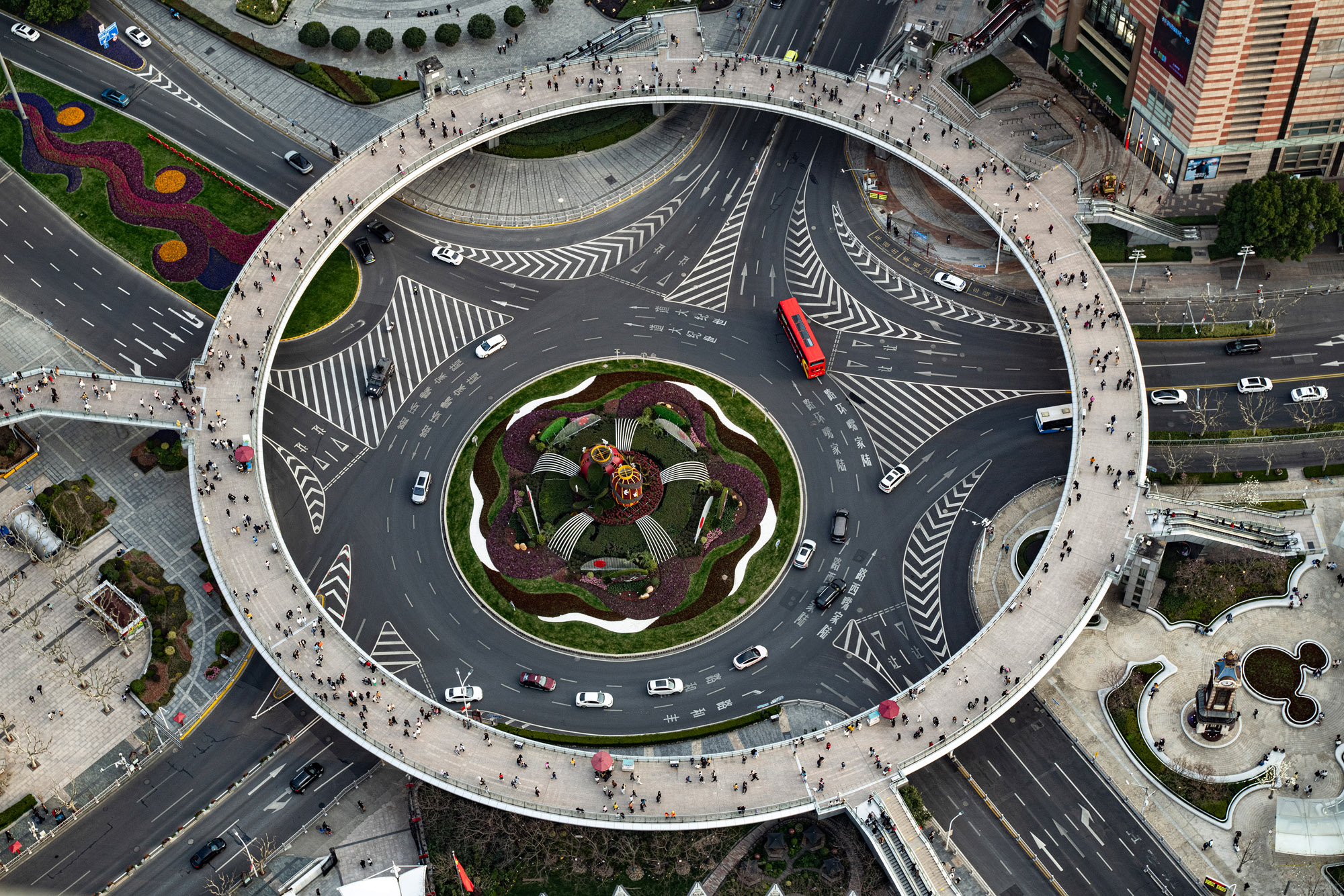 A pedestrian circular walkway sits above a car intersections