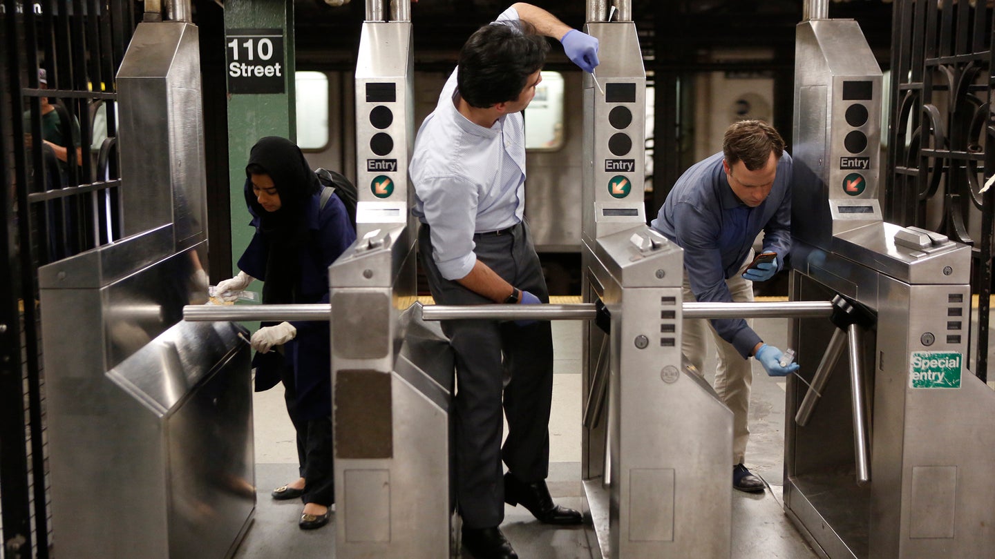 Geneticist Chris Mason (right), Evan Afshin (center), and Sofia Ahsanuddin (left) sample turnstiles in New York City’s subway system in June 2016. Their swabs pick up cells that humans, animals, and microorganisms naturally shed, leaving behind genetic fingerprints.