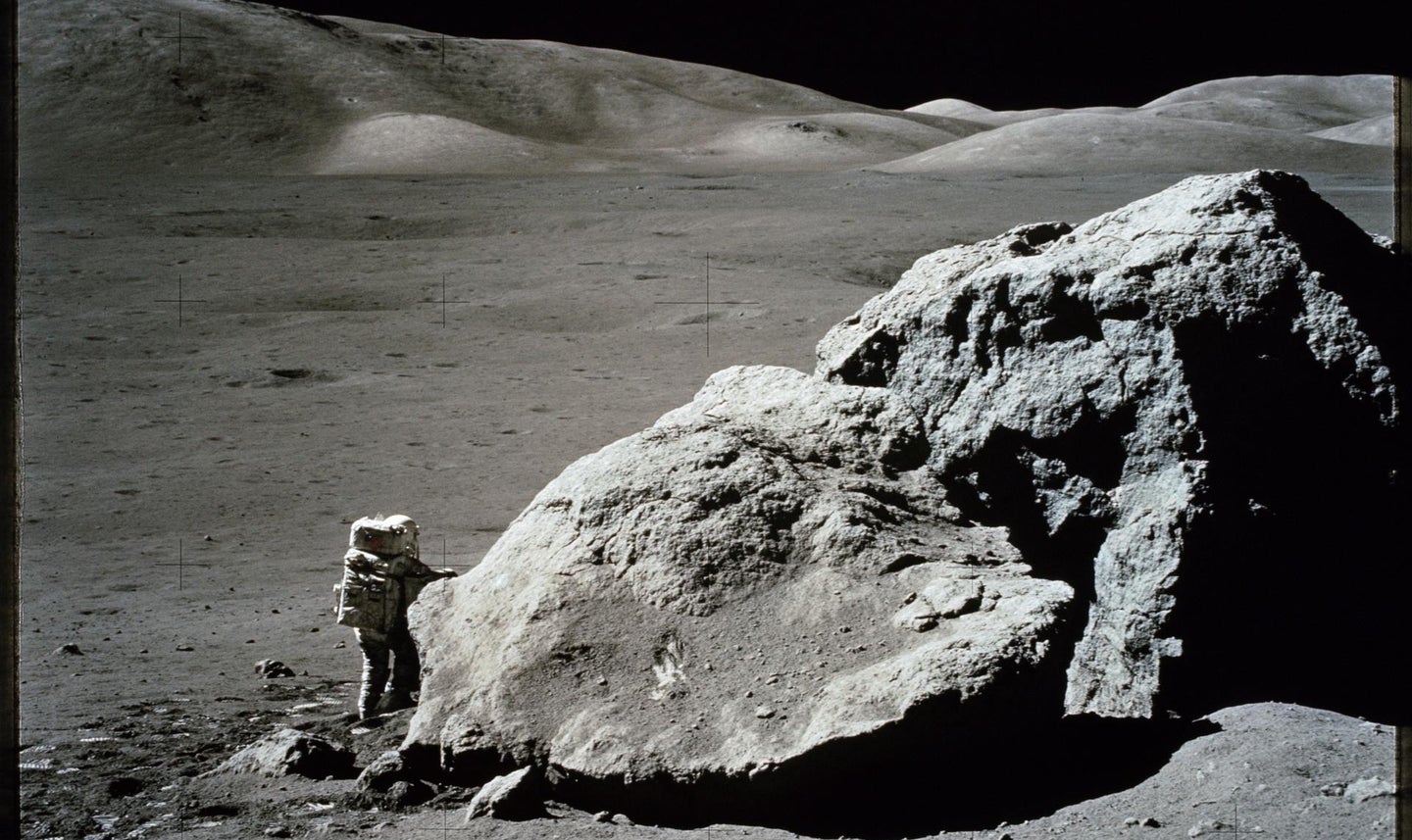 large boulder with astronaut