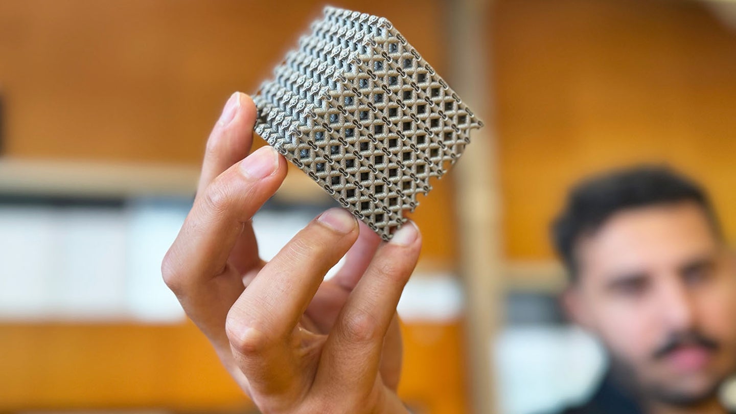 Hand holding cube of 3D printed titanium allow metamaterial