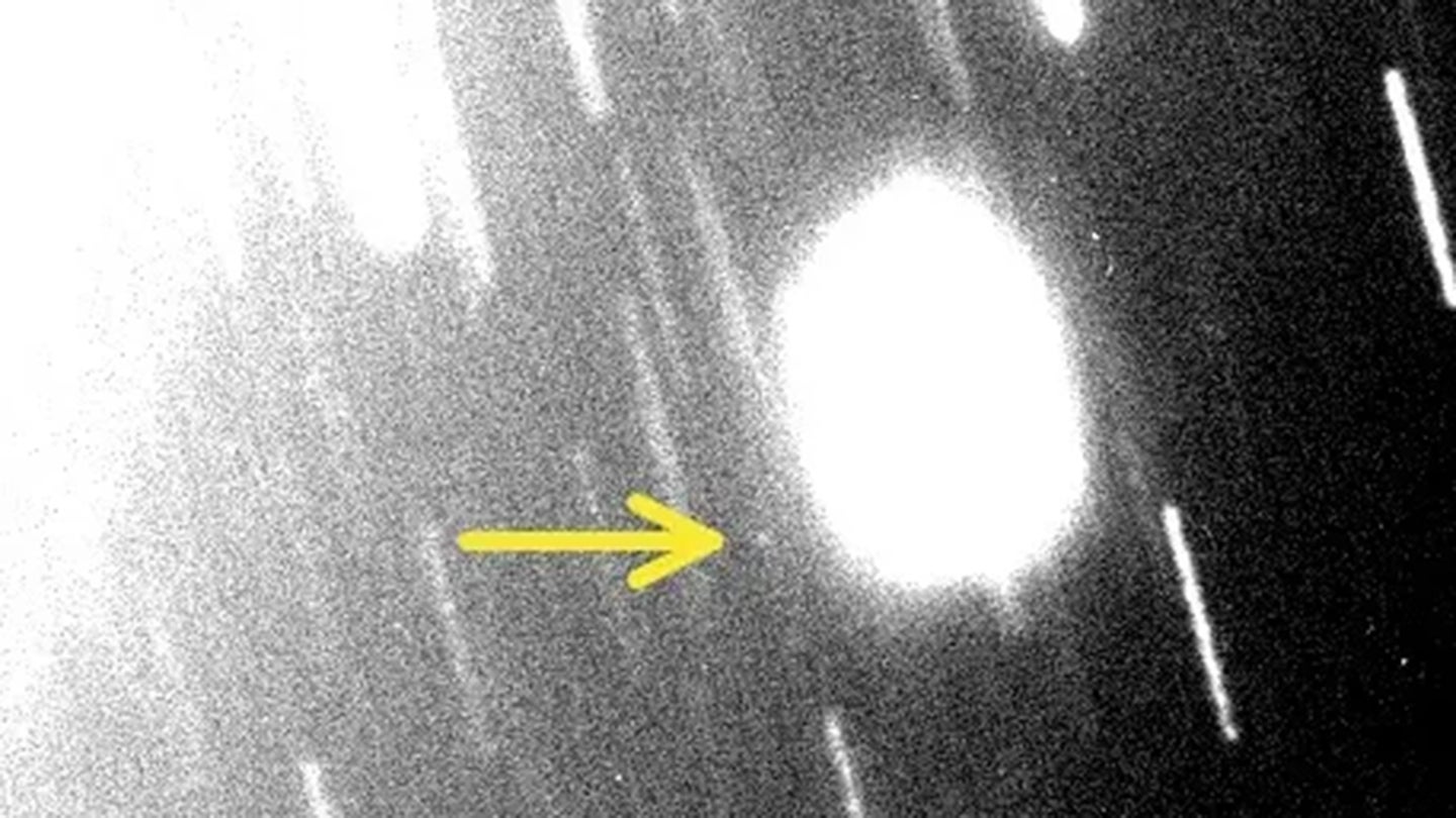 The discovery image of the new Uranian moon S/2023 U1 using the Magellan telescope. Uranus is just off the field of view in the upper left, as seen by the increased scattered light. S/2023 U1 is the faint point of light in the center of the image with the arrow pointing to it. The trails are from background stars.