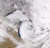 A lake-effect snowstorm in 2020 shows how cold, dry air passing over the Great Lakes picks up moisture and heat, becoming snow on the other side. Credit: NASA
