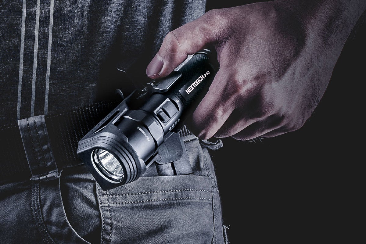 A person holding a P80 Pocket Torch emergency flashlight.