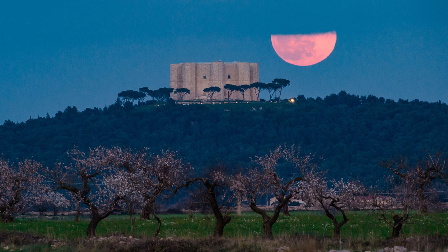 The full moon rises behind the Castel del Monte in Andria, Italy on March 7, 2023. March's full moon is also called the worm moon.