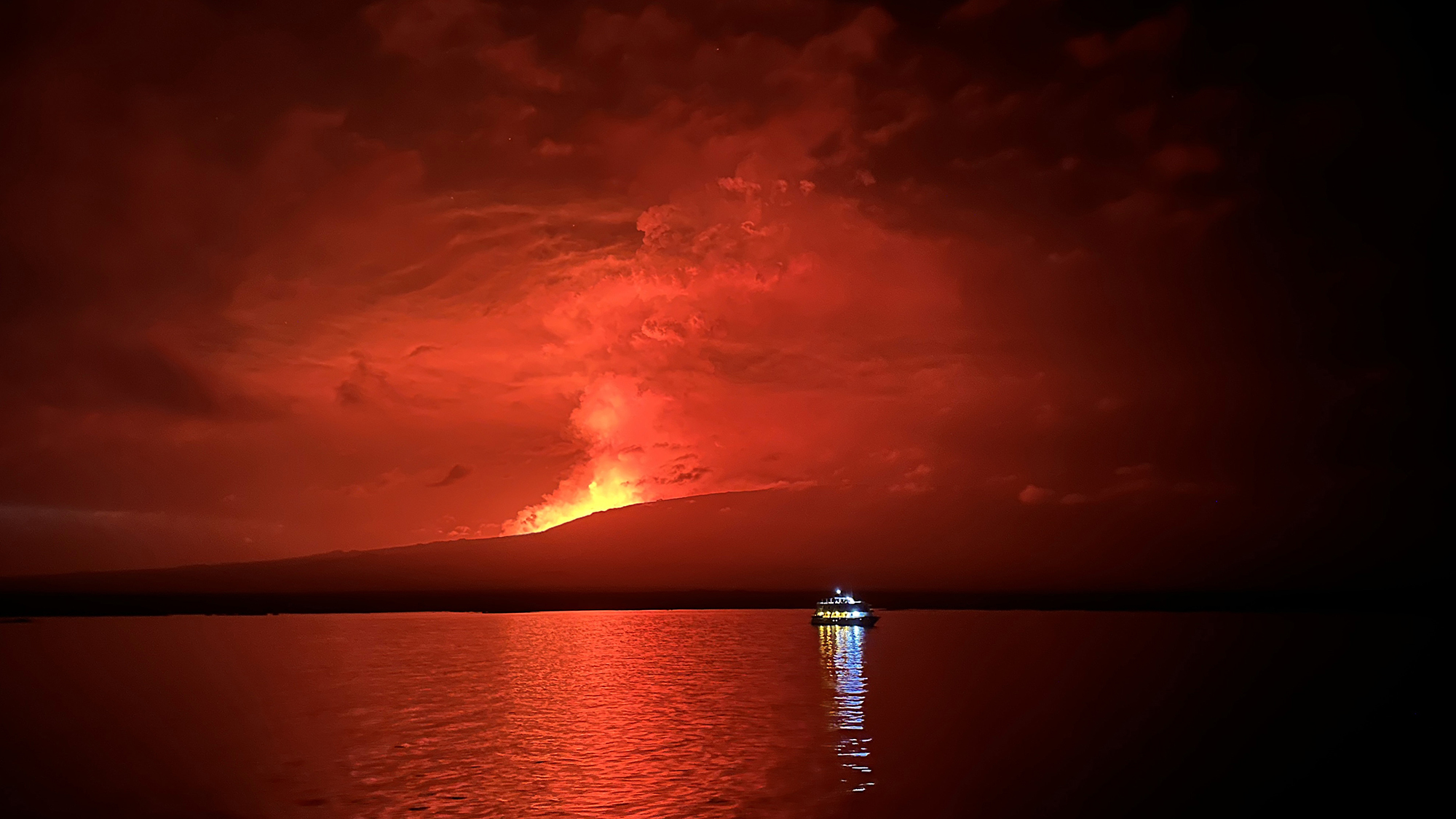 Firey lava spews out La Cumbre volcano on March 3, 2024 in Galapagos Islands, Ecuador. La Cumbre volcano, located on Fernandina Island of the archipelago, erupted on Saturday, March 2.