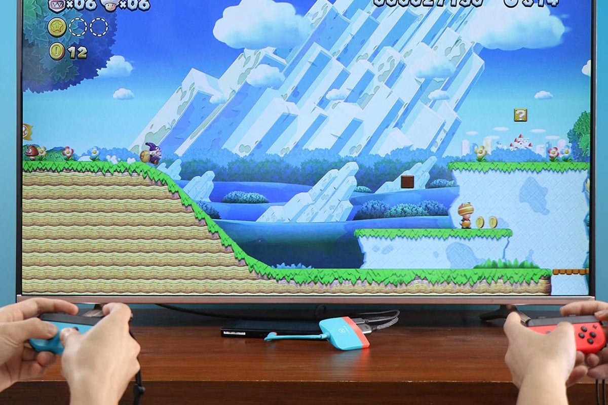 Two people playing a Mario game on their Switch via the television.