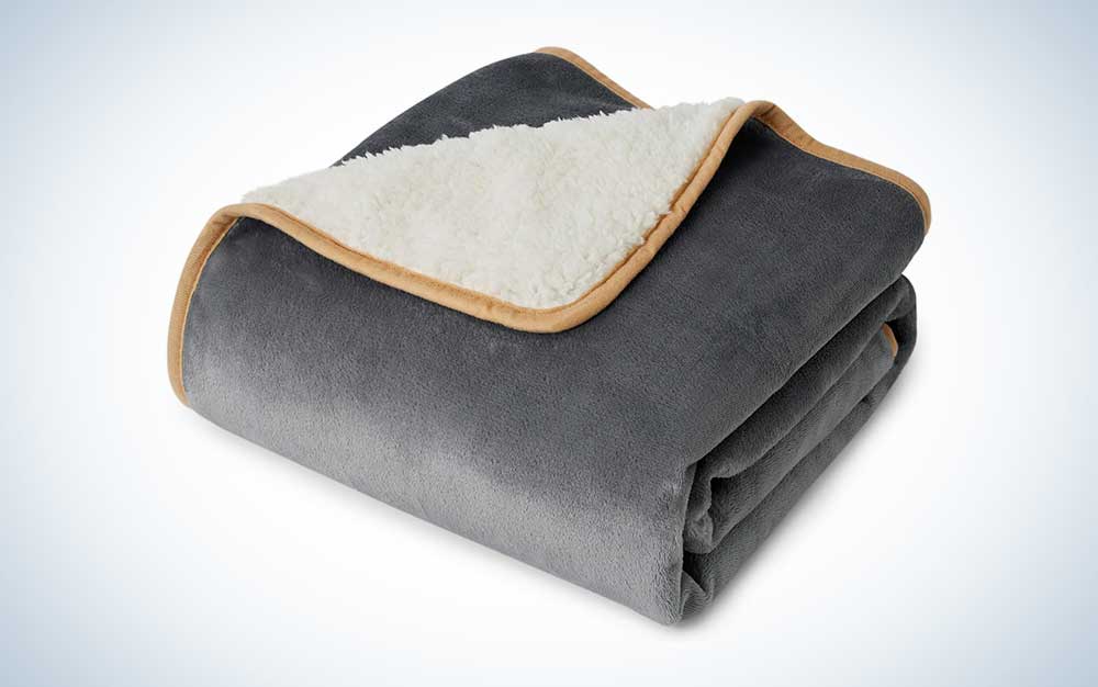 A gray fleece and white Sherpa Bedsure dog blanket on a plain background.