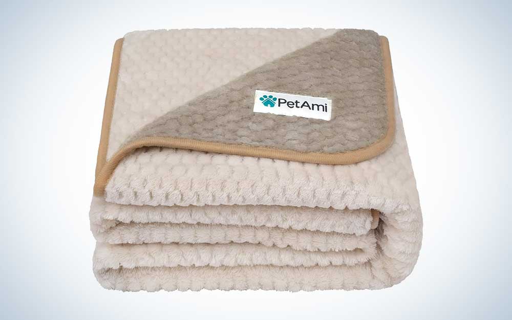 A tan PetAmi waterproof throw blanket for dogs on a plain background.