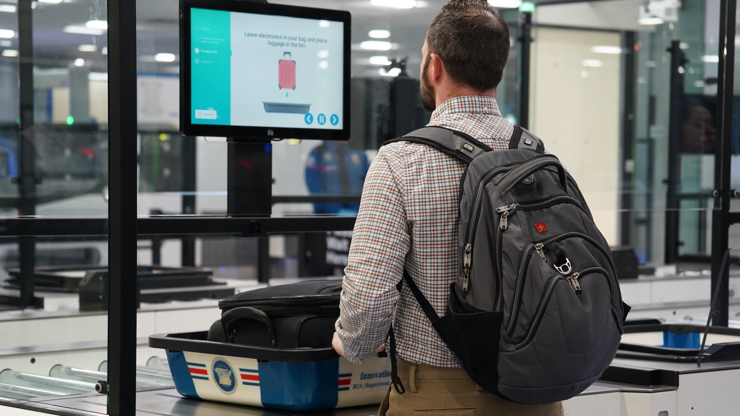 Passenger staying at self-scan TSA station