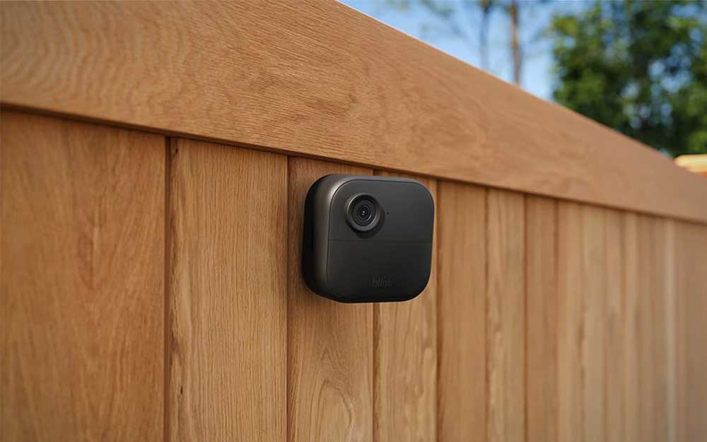 A Blink outdoor camera on a fence