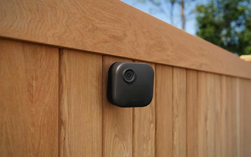 A Blink outdoor camera on a fence
