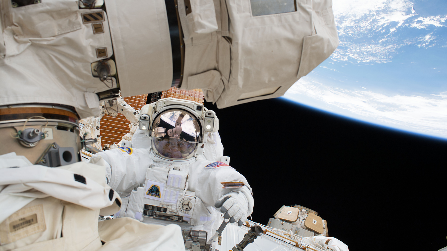 NASA astronaut Scott Tingle is pictured during a 2018 spacewalk to swap out a degraded robotic hand on the Canadarm2.