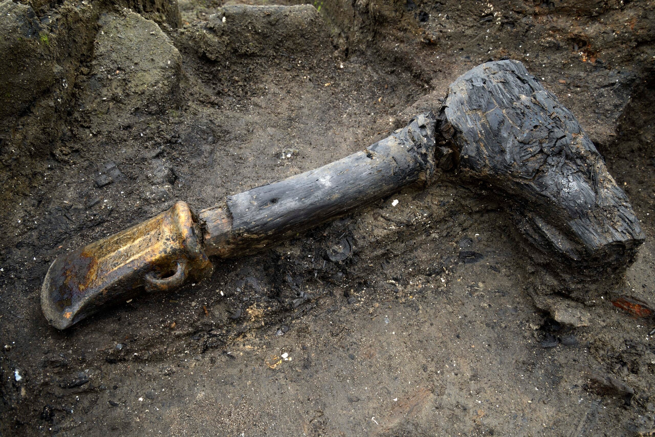 an ax in the mud at the excavation site