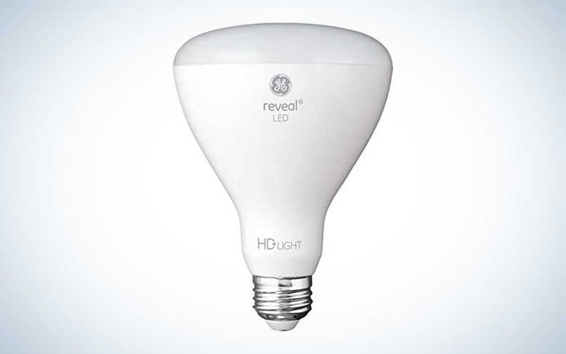 A white GE Reveal LED light bulb for for recessed lights on a plain background.
