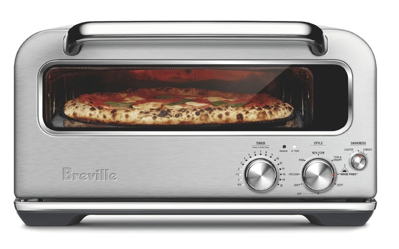 Breville Pizza Oven with a pizza inside on a plain background