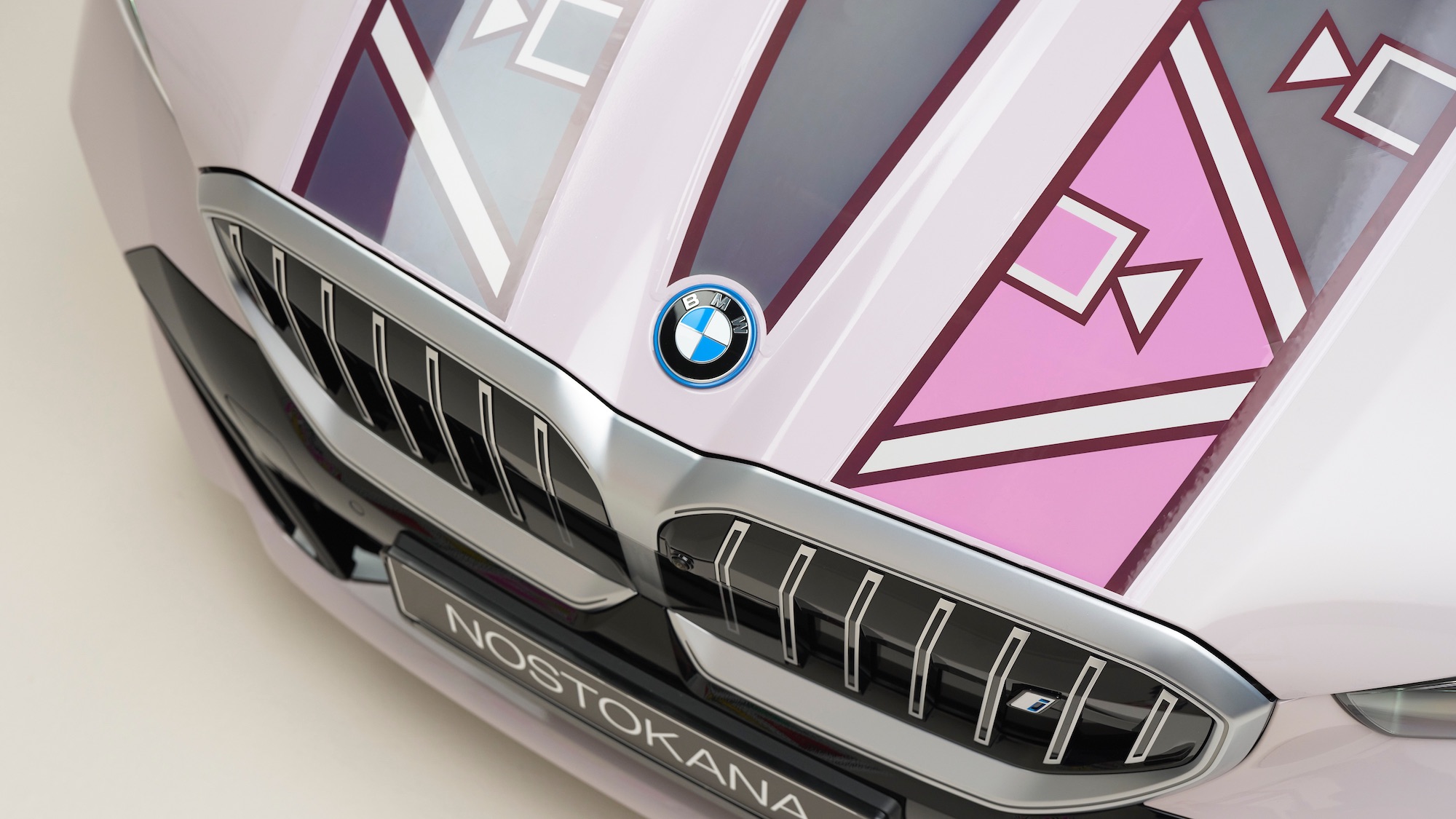 the hood of a BMW painted with pink, grey, and purple colors
