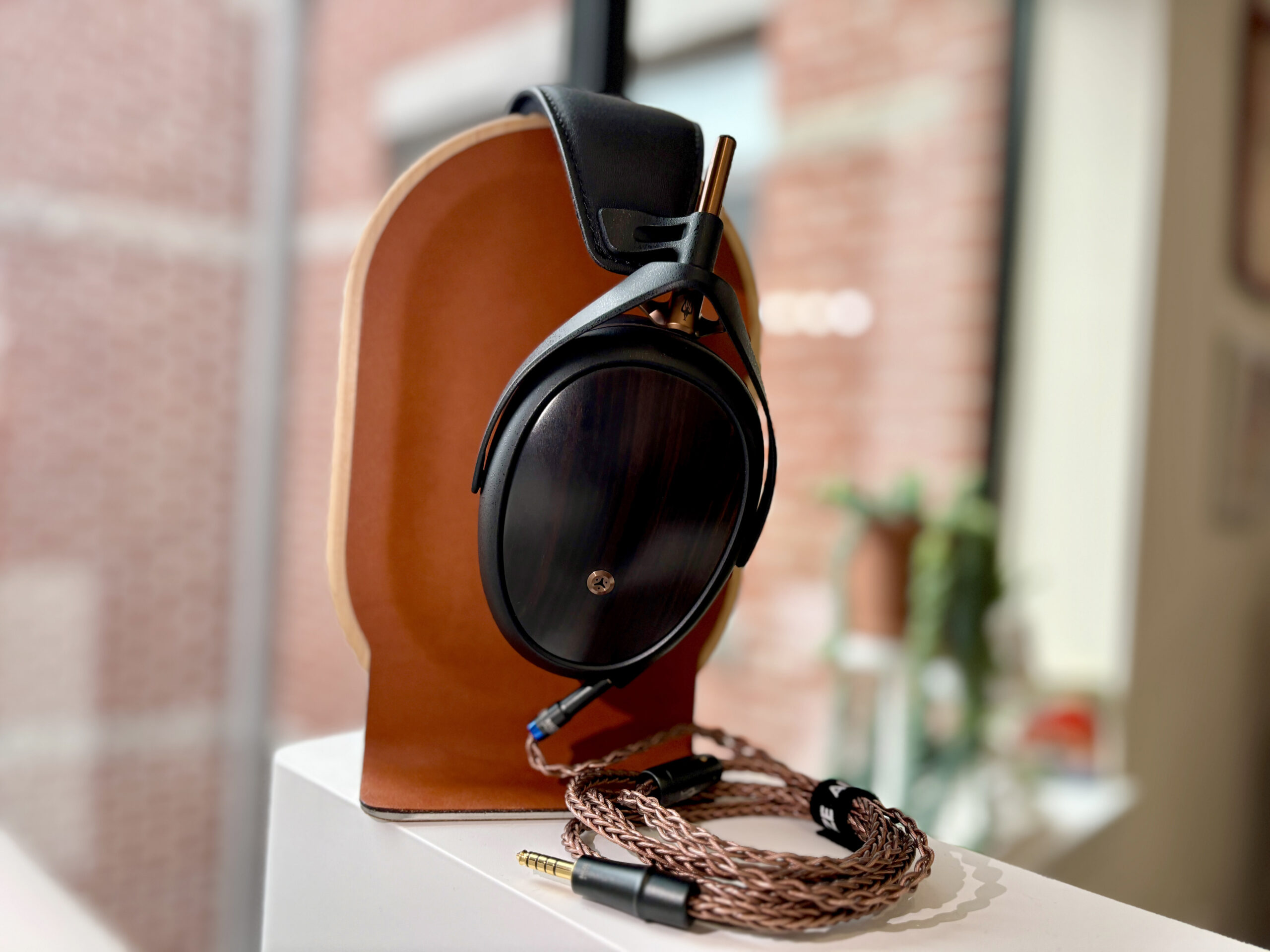 Meze Liric II headphones on a stand.