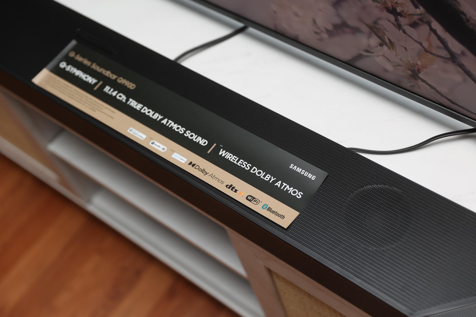 Samsung 990D soundbar in front of a TV