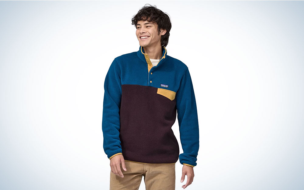 A person wearing Patagonia's Synchilla pull-over fleece on a plain background