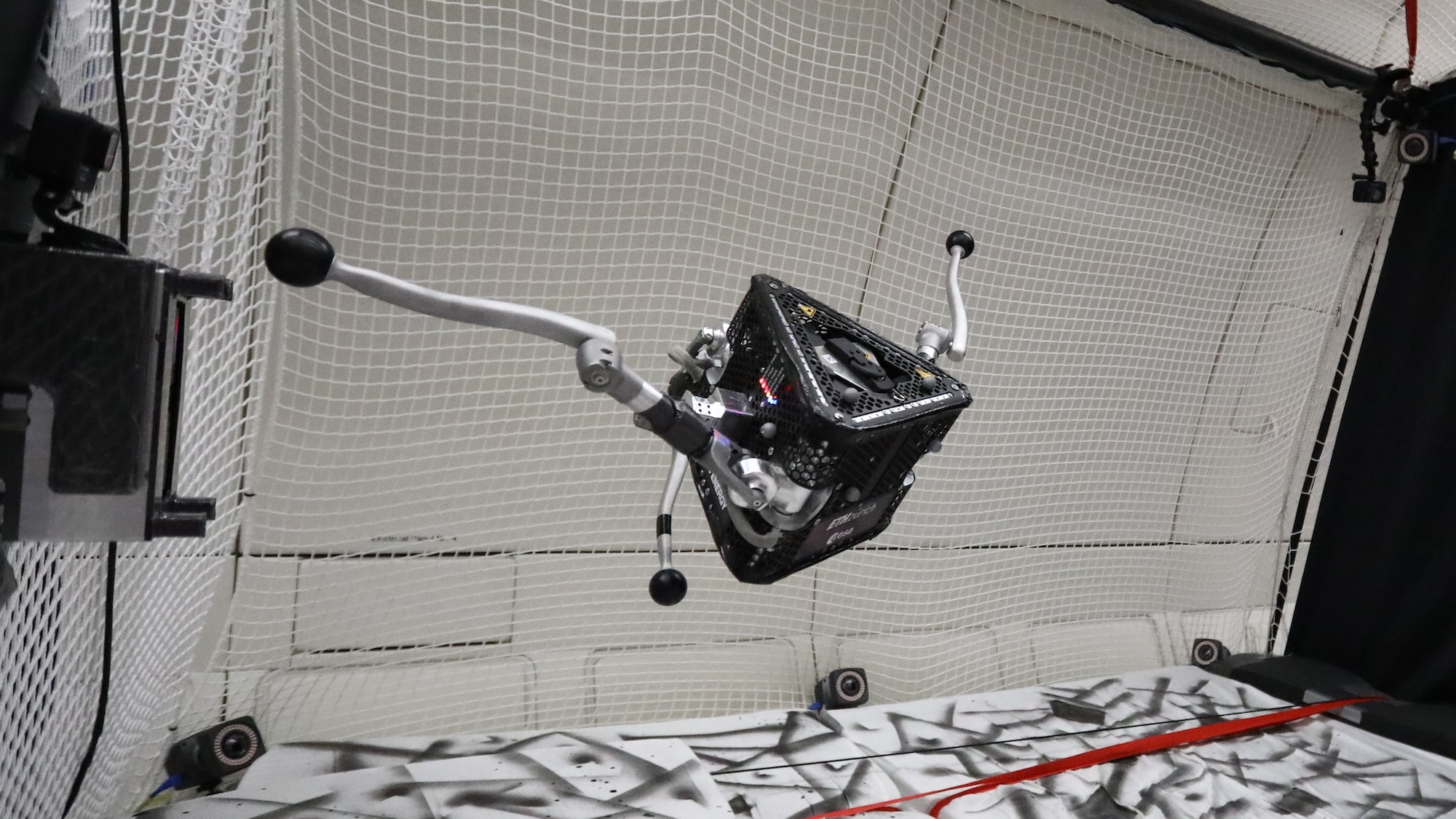 SpaceHopper robot in midair during parabolic flight test