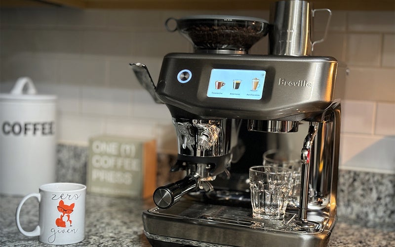 Breville-Barista-Touch-Impress-Espresso-Machine-with-Grinder on a countertop.