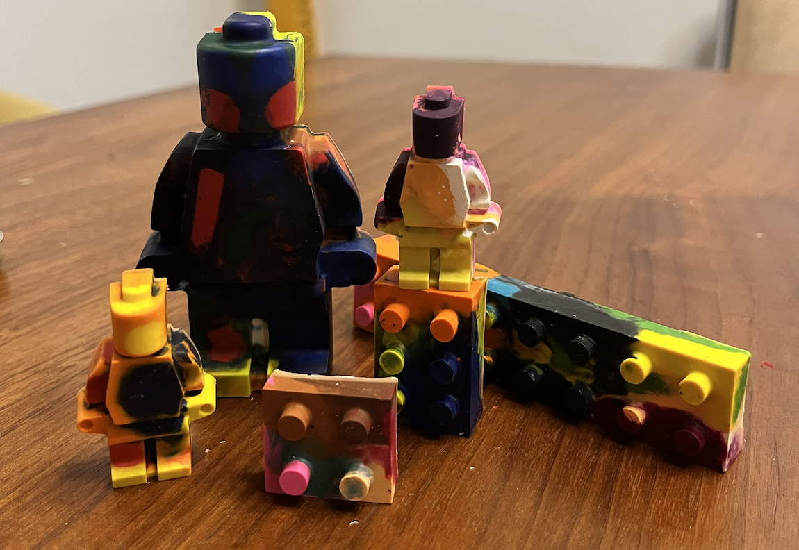 colorful crayons in the shape of lego bricks and lego minifigs