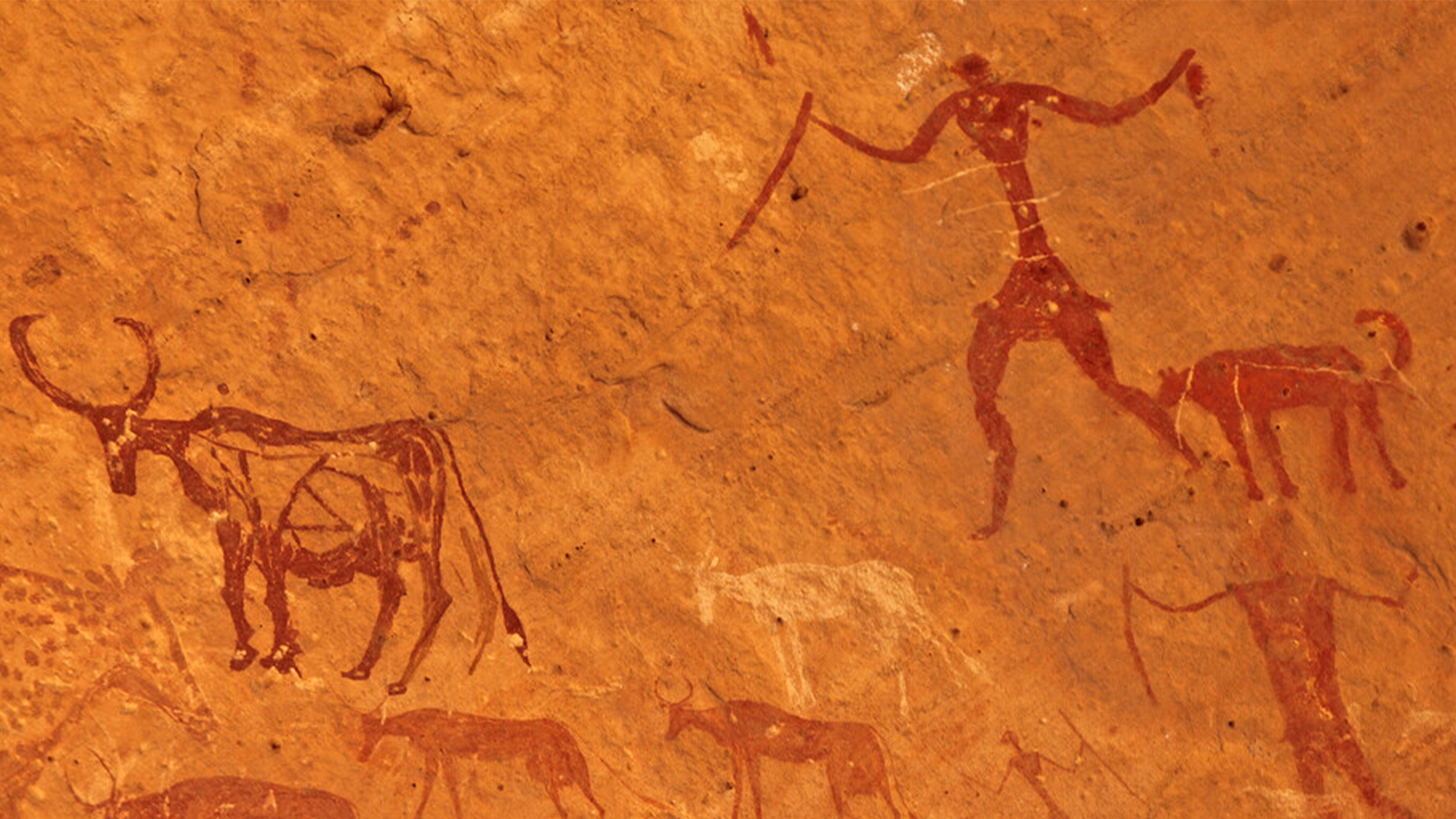 rock art depicting a human hunting various animals