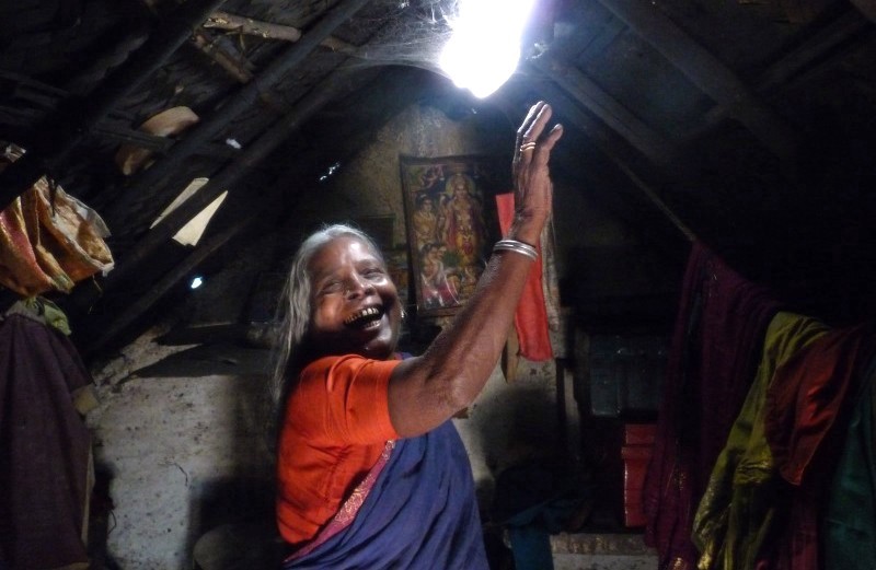 A woman enjoys the natural light refracted by water in a bottle