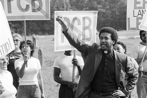 A man holds up a fist during a protest against the landfill.