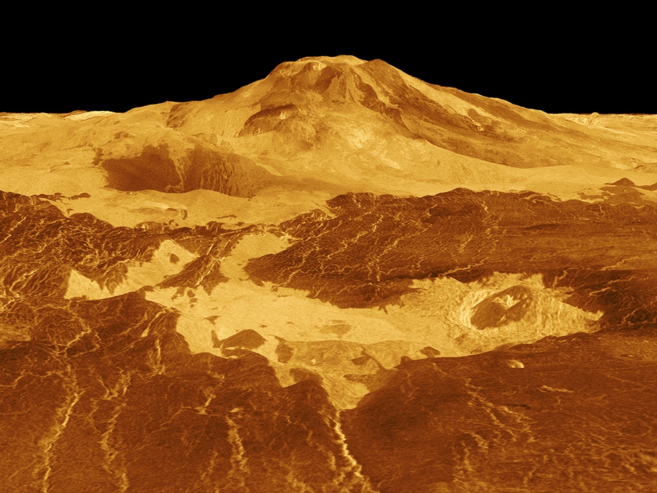 Lava flows extend for hundreds of kilometers across the fractured plains shown in the foreground, to the base of Maat Mons on Venus.