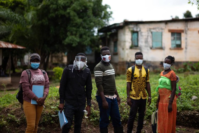 aid workers in Africa go door-to-door to deliver accurate information about Covid-19