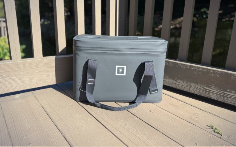 Iron Flask Soft Cooler Bag on a wooden deck.