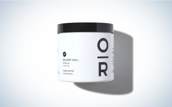 A bottle of see spot chill CBD treats on a blue and white background