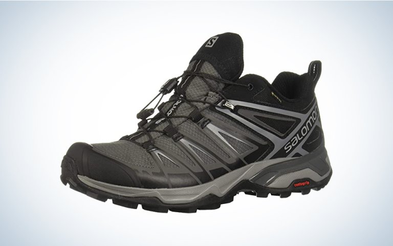 A pair of gray low hiking boots on a blue and white gradient background